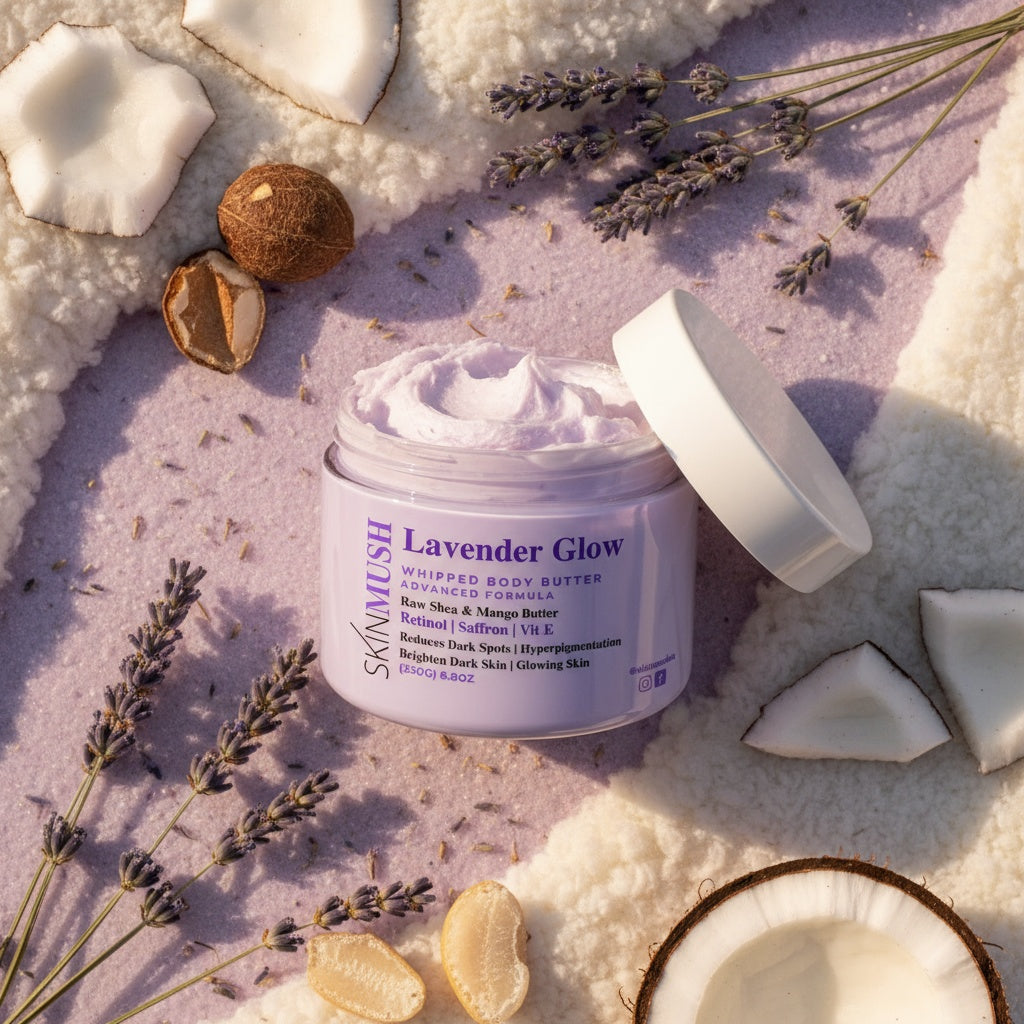 Jar of Lavender Glow body butter surrounded by lavender flowers and coconut pieces on a soft background