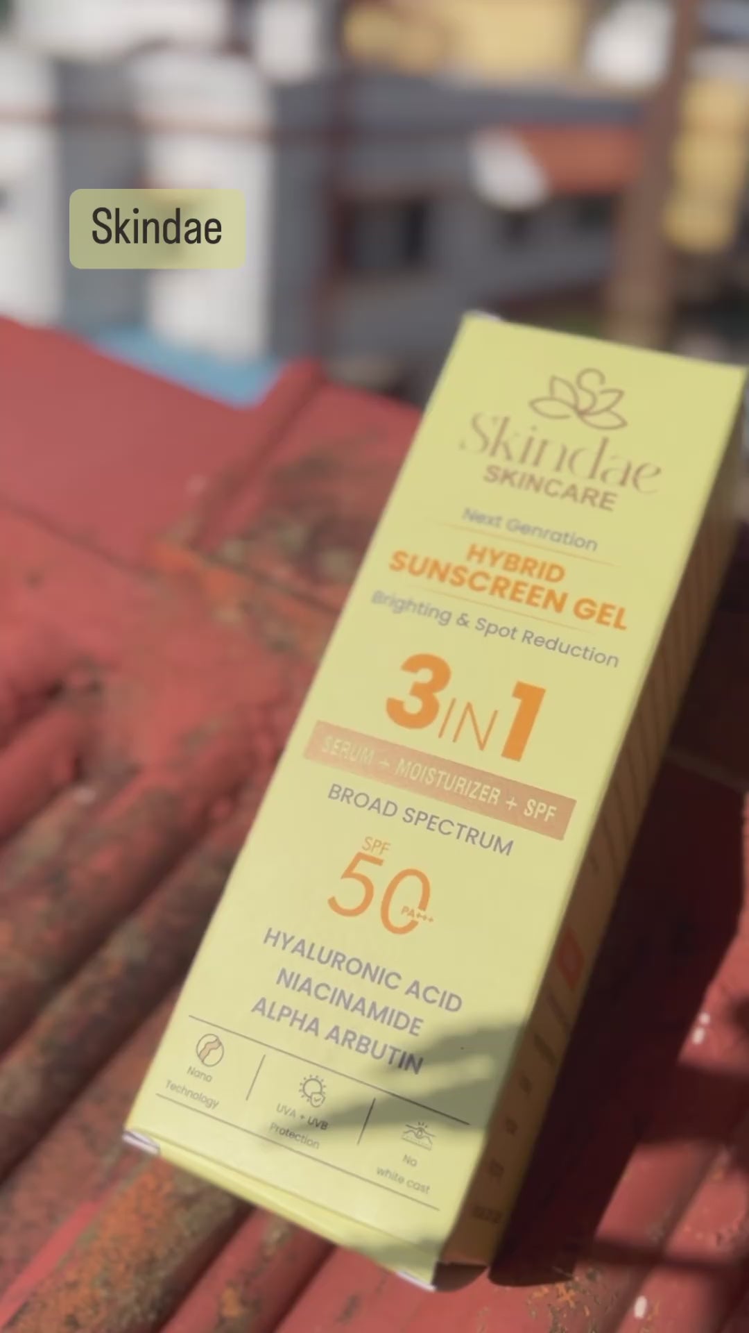 Woman applying Skindae Hybrid Sunscreen Gel SPF 50 on face for brightening, hydration, and UV protection